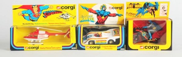 Lot of 3: Die Cast & Plastic Corgi Superhero Toys: No.929 Daily Planet Superman Jetcopter, No.262 Captain Marvel Porsche, and a No.268 Bat Cycle with Batman figure. Slight creasing and wear to boxes. Condition (Very Good -Excellent). Size Largest Box:
