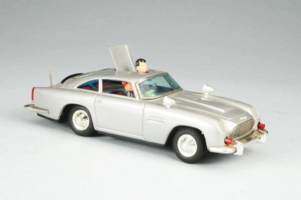 Gilbert James Bond Aston Martin.: Battery operated. Toy is all original complete with figure. Does have slight dent to roof and slight edge wear. Comes with original box with inserts. Some creasing to original box. Condition (Very Goo