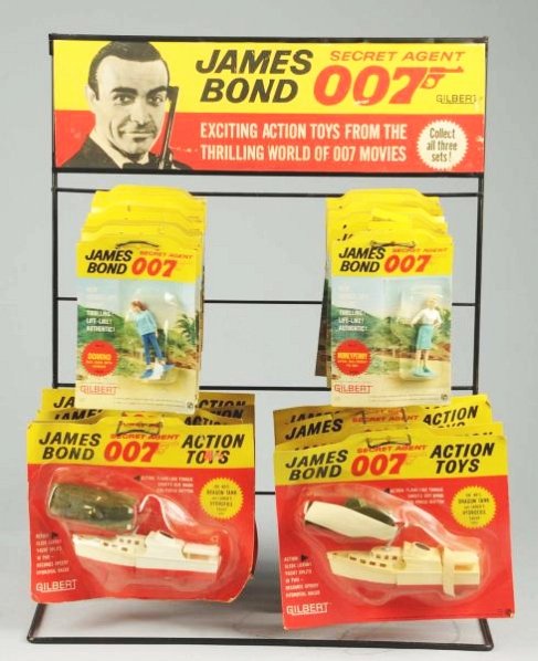 Gilbert James Bond Store Display.: Extremely rare. Circa 1960s. Shows a picture of Sean Connery. Includes 23 Bond related figures which are all marked 1965 Glidrose Productions. They are all sealed. Cards have some creasing and wear. A