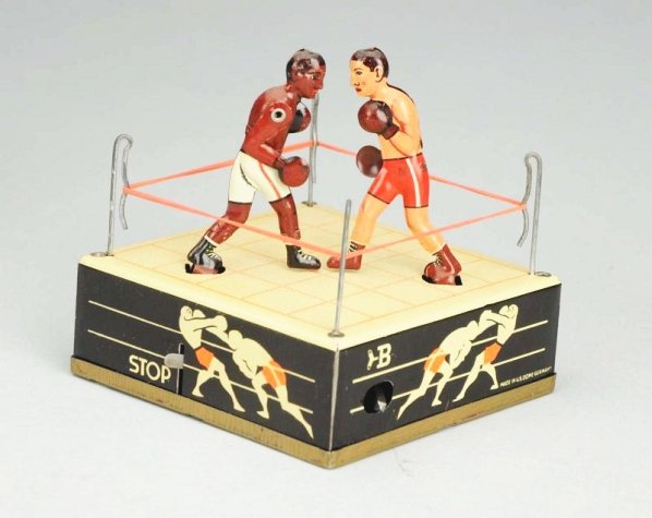 German Tin Litho Wind-up Boxing Toy.: Includes very colorful, crisp, original box marked "Made in Germany - US Zone". Depicts black and white fighters boxing in ring. Very little wear. Condition (Excellent - Near Mint). Size 3 - 3/4" L.