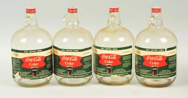 1960s Box with 4 One gallon Coca-Cola Syrup Jugs.: All have paper labels, with light wear, soiling, stains and tears. Condition (Very Good). Size 12 - 1/2" x 14" x 14".