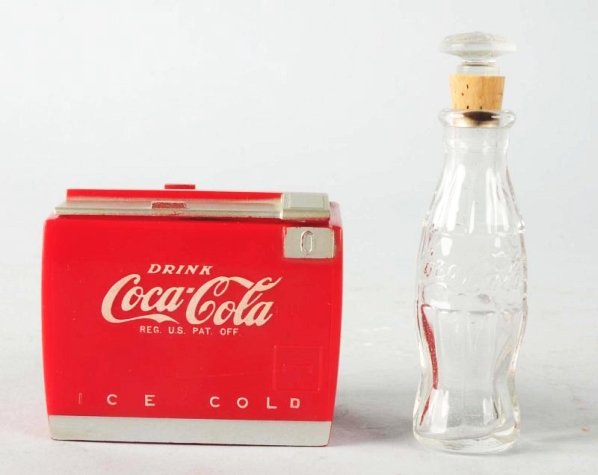 Coca-Cola Perfume Bottle & Music Box.: Almost no wear on either piece with a small hairline crack on the lower front portion of the cooler. Condition (Excellent - Near Mint). Size Largest: 3 - 1/4" T.