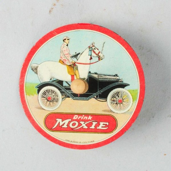 1920 Moxie Tin Spinner.: Litho images on top and bottom of tin. Clean and bright with only the lightest of wear on either side. Condition (Near Mint). Size 2 - 1/2" Dia.