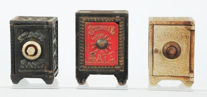 Lo of 3: Cast Iron Safe Still Banks.: Includes a State bank, a security safe and a white city puzzles bank. Condition (Very Good - Excellent). Size Largest: 4 - 1/2" T.