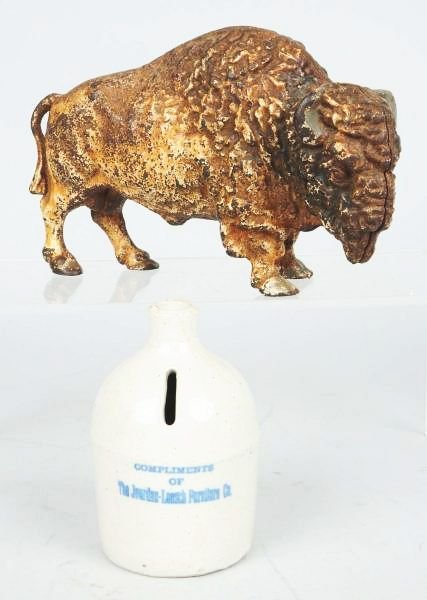 Lot of 2: Cast Iron Still Banks.: Includes a buffalo and a pottery jug. Condition (Very Good - Excellent). Size Largest: 8" L.