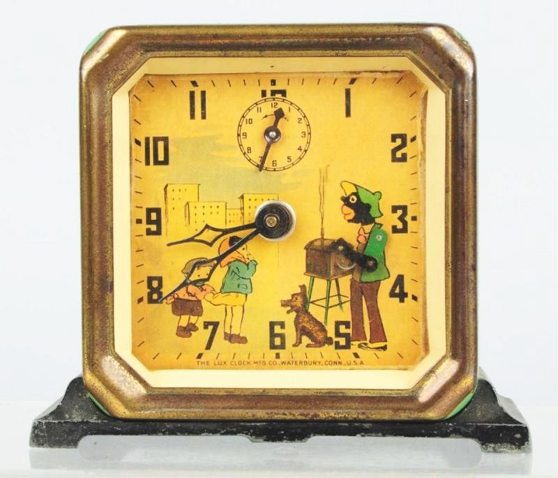 Black American Organ Grinder Clock.: Made by Lux Clock Company. Paint wear as shown. Circa 1930s. Condition (Good). Size 4" T.