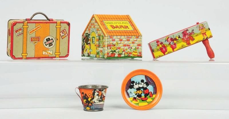 Lot of Misc. Tin Character Toys.: Pigs Japan noise maker. A Chein Three Pigs Bank. Mickey Mouse tin cup and saucer. A tin Marx suitcase bank. Circa 1930s - 1940s. Condition (Very Good). Size 4 - 1/4" L.