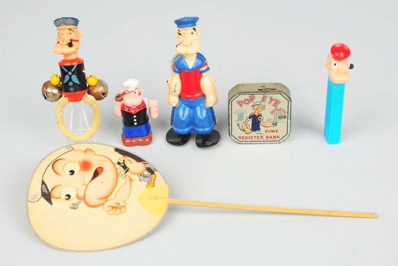 Lot of 6: Popeye Items.: Dime bank, Pez dispenser, celluloid walker, rattle, and fan. Condition (Good). Size Largest: 12 - 1/2" L.