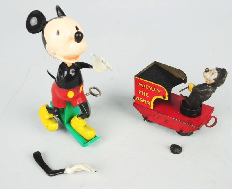 Lot of 2: Mickey Mouse Plastic Toys.: Arm has broken off but possibly could be repaired. Also, a Mickey Mouse the Stoker Wales London toy from English Mickey Mouse train set. Missing one ear. Tin has some wear. Condition (Good). Size Larg