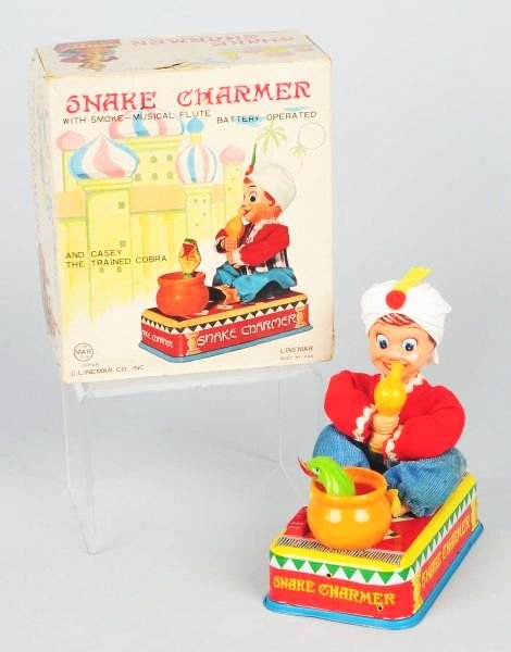Japanese Linemar Battery Operated Snake Charmer.: Includes original box. Box has minor creasing and wear to corners. Box has cardboard inserts. Toy has very minimal wear. Condition (Excellent - Near Mint). Size Box: 8 - 3/4" T.