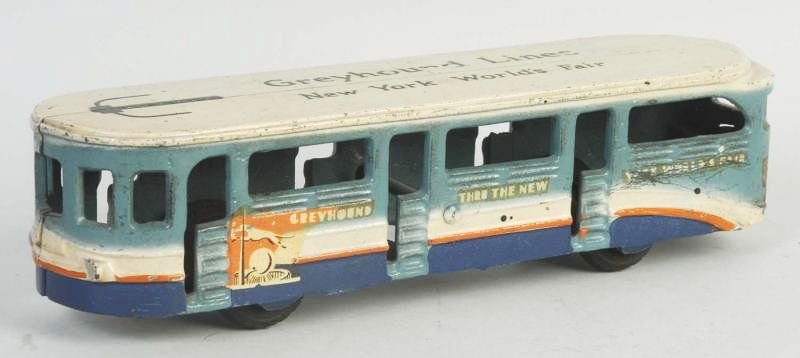 Cast Iron Arcade Greyhound Lines Bus.: "New York World's Fair" written on top. Decals on sides. Black rubber tires. Embossed "Arcade" on inside. Some minor scratching and wear. Condition (Very Good - Excellent). Size 8 - 1/4" L.