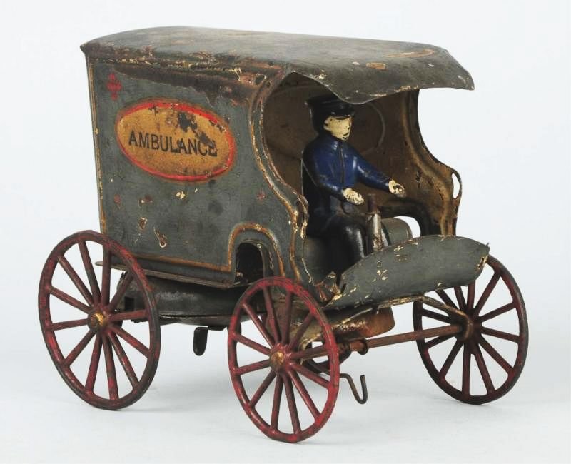 Early Kingsbury Wind-up Ambulance Toy.: Has original cast iron driver. Missing the steering wheel. Appears to have some repaint throughout. Condition (Good). Size 7" L.