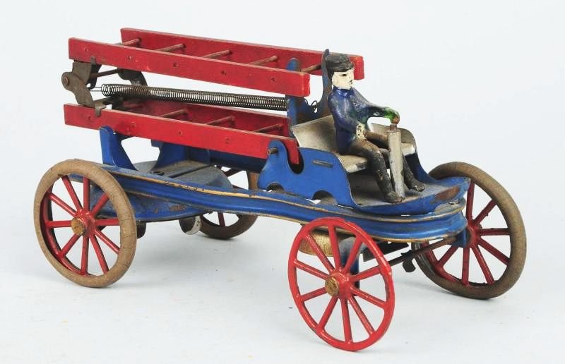 Early Kingsbury Wind-up Ladder Truck.: Trucks appears to be all original including wooden ladders and cast iron driver. Missing the steering wheel. Has some flattening to the rubber tires and some scratching throughout. Condition (Very Goo