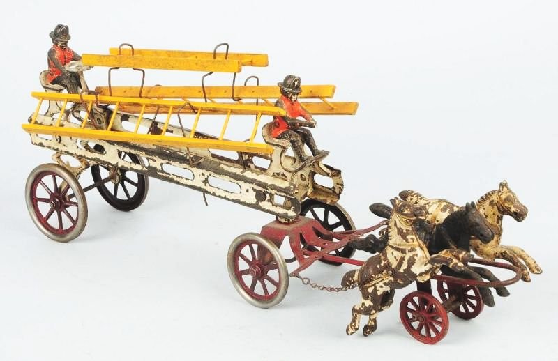 Cast Iron & Pressed Steel Fire Ladder Wagon.: Has two original cast iron drivers, and three articulated horses in front. Has three wooden ladders which look to be repainted. Wire hangers. Hubs have been repainted on the four wheels. Significant p