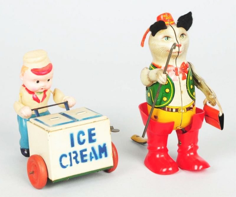 Lot of 2: Foreign Made Wind-up Toys.: Includes occupied Japanese ice cream vendor with a tin celluloid figure and a tin ice cream case. Also includes a tin litho puss n boots. Has plastic boots. Made in Germany. Also has felt ears. Some s
