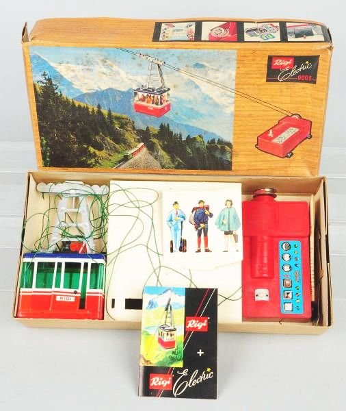 Lehmann Rigi Electric Cable Car.: Car appears mostly complete in original box with instructions and inserts. Box is dirty with some creasing and tearing. Condition (Excellent). Size Box: 16 - 3/4" x 8 - 1/4".