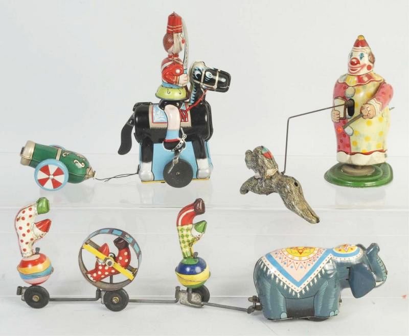 Lot of 3: Tin Wind Up TPS Toys.: From Japan. Includes a soldier on horse with cannon. A clown with trick dog and an elephant pulling clowns. All appear original and complete. Does have some scratching and wear throughout. Condition (