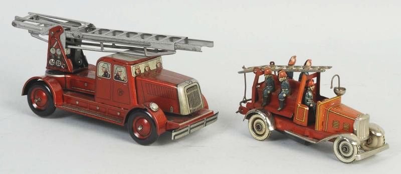 Lot of 2: German Tin Wind Up Fire Engines.: First is a CKO ladder truck. Truck is all original. Has some wear and scratching throughout. Second is a Ditsler fireman ladder truck. Has original fireman an ladder. Condition (Very Good - Excellent)