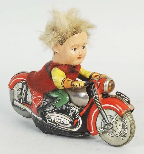 German Schuco Peter Motorcycle Toy.: Original felt clothing and hair. Some soiling to clothing. Marked "Peter 1013" on bottom. Condition (Very Good - Excellent). Size 5" L.