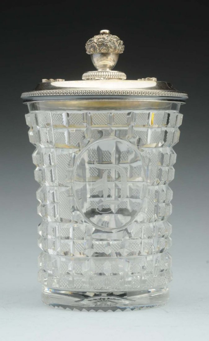 Continental Glass & Silver Covered Beaker.: The silver cover Vienna 1826, makers mark unclear possibly LB or LR, flat with a ring of floral bossed around a cast floral finial and with a milled edge, the beaker cut with square panels around an o