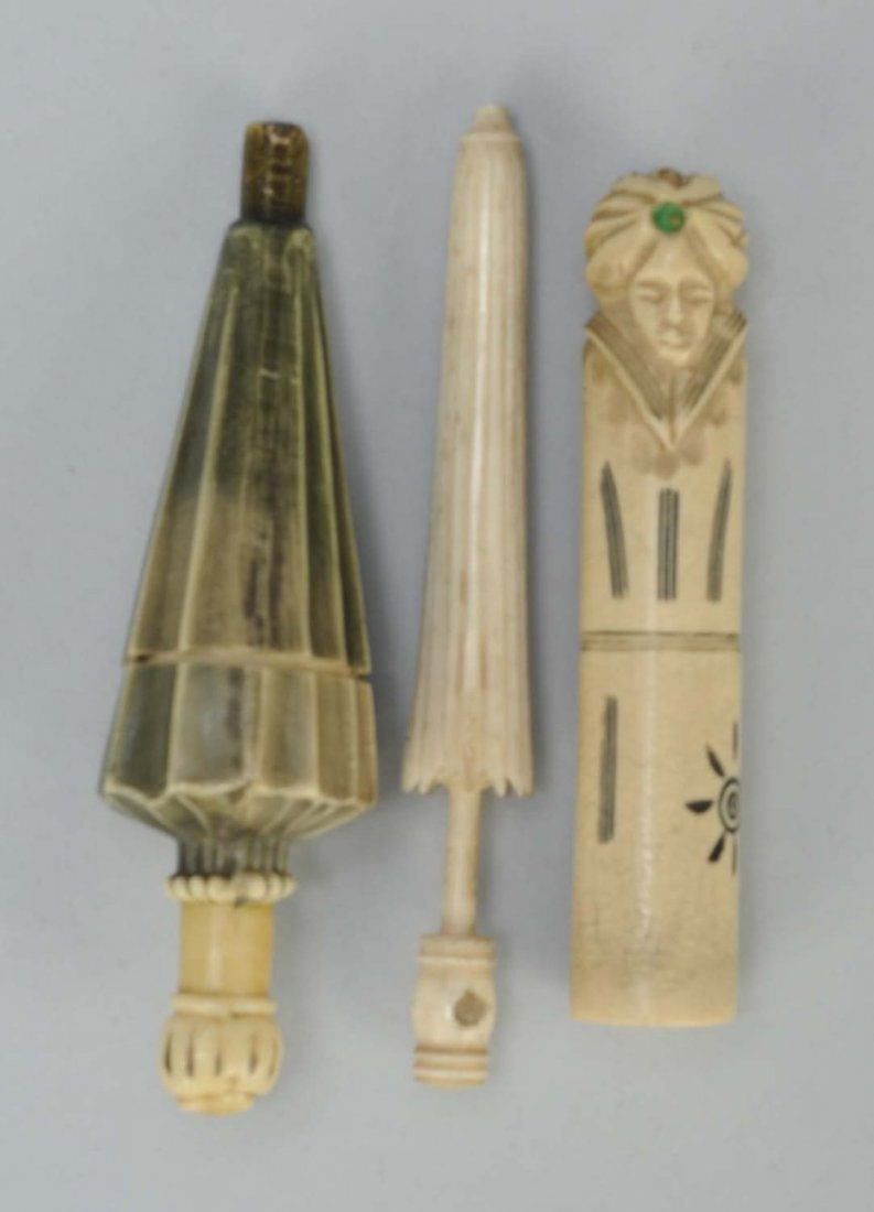Lot of 3: Figural Sewing Needle Cases.: One is celluloid in the form of an umbrella. Second is celluloid with a man in jeweled turban. Third is an ivory umbrella form with stanhope. Condition (Excellent). Size Largest: 3 - 3/4" L.