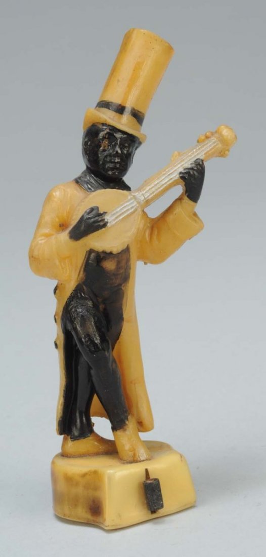 Celluloid African American Figural Tape Measure.: Rare. With top hat. Playing the banjo. Full full spring tape. Condition (Excellent). Size 4 - 1/2" T.
