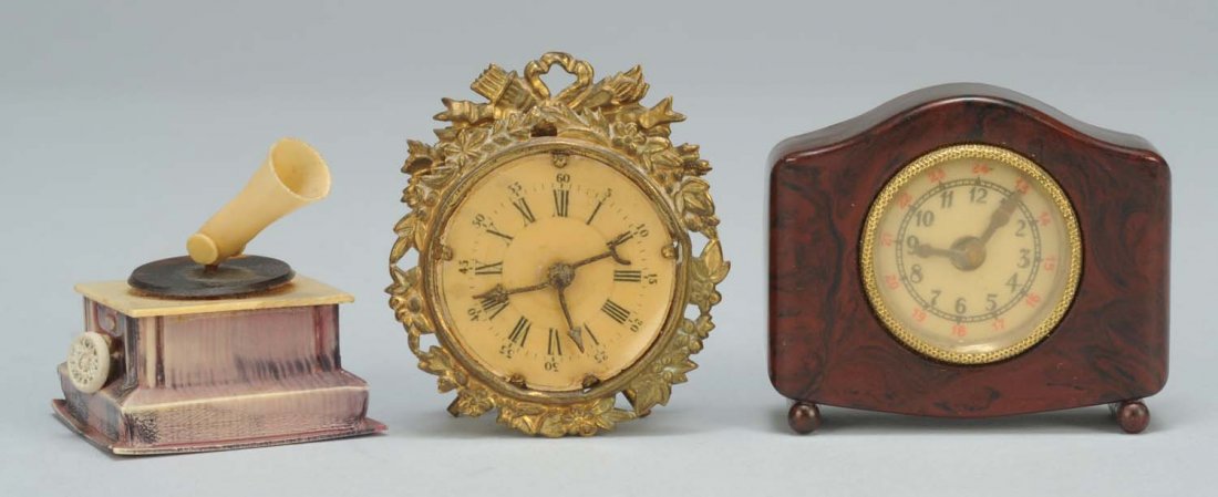 Lot of 3: Figural Sewing Tape Measures.: One is a phonograph with full windup tape. Second, is a bakelite clock with full spring tape. Last, is a Victorian clock with full windup tape. Condition (Excellent). Size Largest: 2" L.