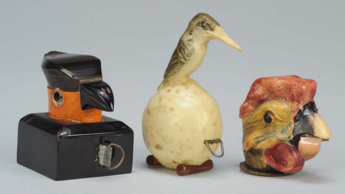 Lot of 3: Celluloid Figural Sewing Tape Measures.: One is Bird on egg. German full spring tape. Second is Art Deco bird with full spring tape. Third is a large beak bird with tongue tab. Full spring tape. Condition (Excellent). Size Largest: 2 - 1/2" 