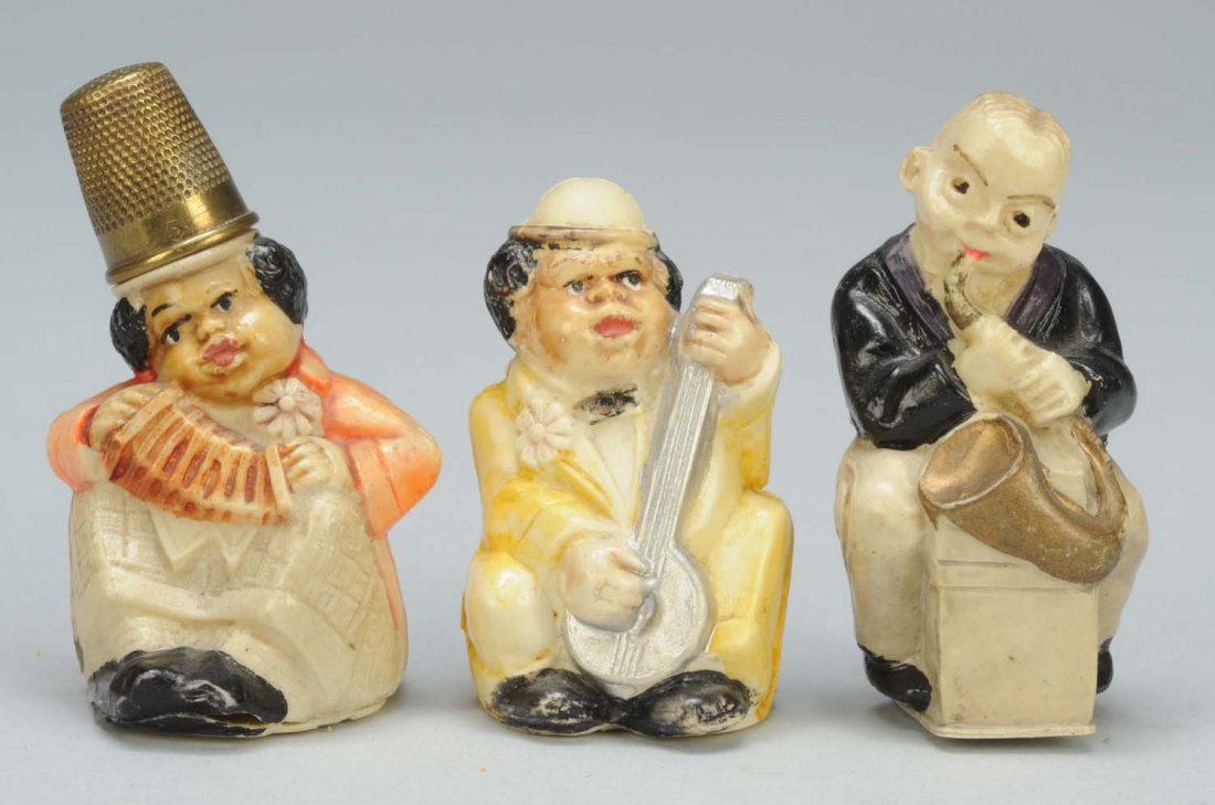 Lot of 3: Celluloid Figural Sewing Tape Measures.: One is African American accordion player with thimble on hat. Full spring tape. Second, is a African American banjo player. Last, is a saxophone player. Condition (Excellent). Size Largest: 2 - 1/4" T
