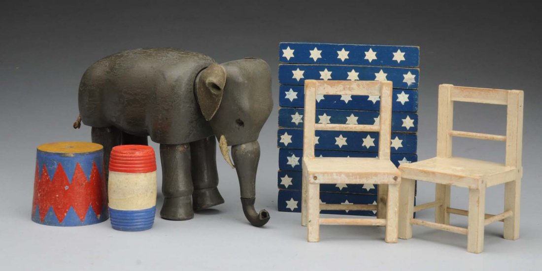 Lot of Schoenhut Circus Items.: All wood elephant with glass eyes and leather ears (repaired tusk), 2 chairs, pedestal, barrel, 8 wood blocks to make a performing ring. Condition (Very Good). Size 8" Long Elephant.