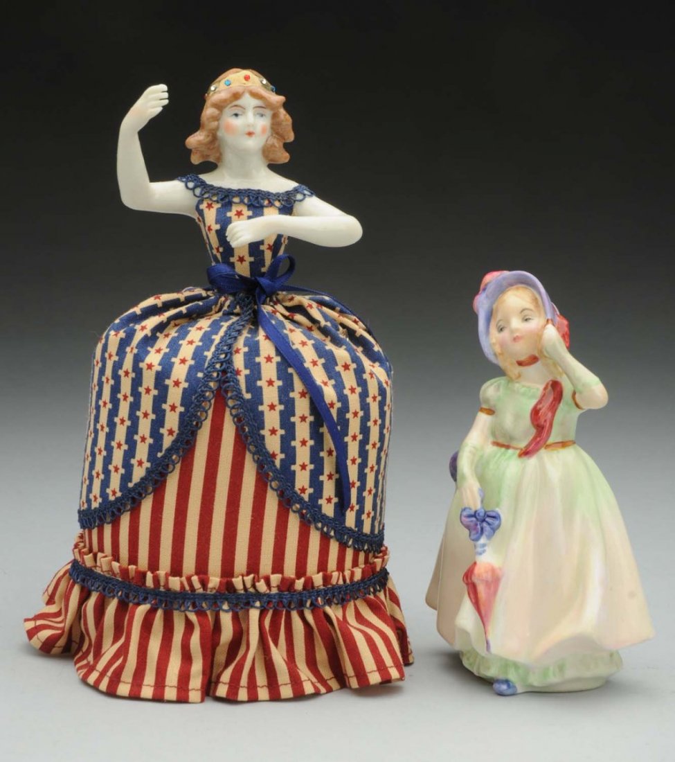 Lot of 2: Figures.: Reproduction china half doll from the UFDC Convention 2011 Luncheon Souvenir by Rosemarie Snyder made up in patriotic outfit with scissors as “Miss Liberty” with flag; Royal Doulton Figurine “Ba
