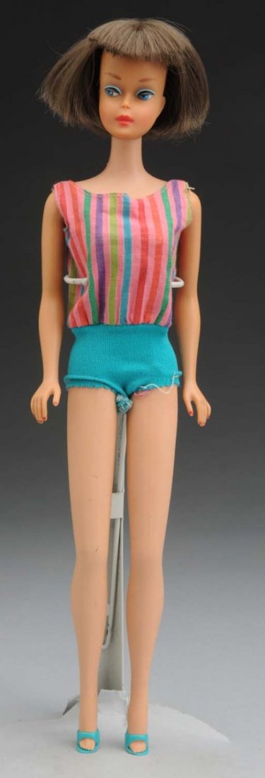 American Girl Barbie Doll.: This American Girl Barbie is a brunette. There is no greening at the ears and no slits in the vinyl. Her bathing suit and shoes are included. She is missing her headband. A great doll with stunning fa