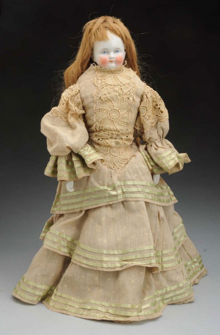 Bald Head China Doll.: German shoulder head with bald head and antique human hair wig; tapered eyebrows, painted blue eyes, red eyelid line, black eyelash line, rosy cheeks, closed mouth; antique cloth body (wear and soil)