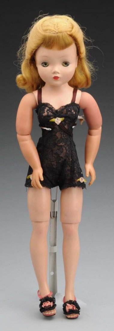 Mme Alexander “Cissy” Doll.: Blonde-haired doll with sleeping hazel eyes (most eyelashes gone, split at head side seam, needs cleaning, vinyl arms discolored, short seam splits on thighs), wearing tagged black lace teddy and high