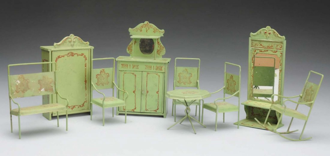 Lot of 9: Tin Doll House Furniture.: Painted green tin with brown stenciled scrolled decoration, probably German. Mirror, dresser with mirror, wardrobe, 3 side chairs, rocking chair, double settee, table. Light wear and soil on most piec