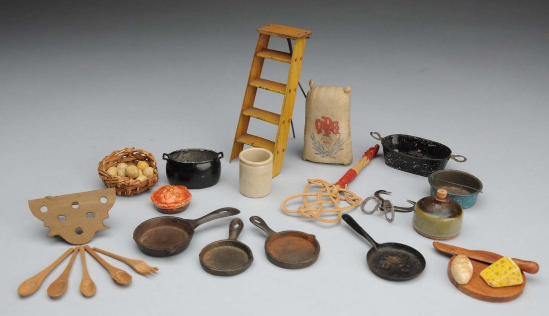 Lot of 17: Antique Doll House Accessories.: Kitchen accessories include 3 cast iron fry pans, 2 tin pans, ice tongs, miscellaneous pans, jug, pie, flour sack, barrel, rug beater, basket with eggs, hanging rack for utensils, cutting board with k
