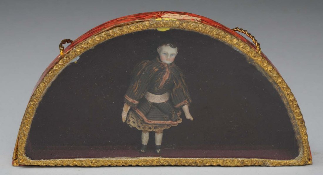 Rare Tiny Antique Doll.: Bisque shoulder head with brown painted and molded hair, fine painted features on a peg wood jointed body, original clothes (some flaking on limbs); tied in a glass-topped display box (box looks old,