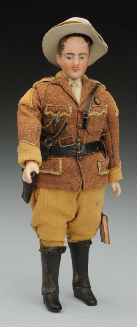 German Doll House Man in Uniform.: Bisque shoulder head with flocked brown hair and painted mustache, cloth body with bisque lower arms and legs with black boots; fabulous original uniform with jacket having whistle, revolver, leather