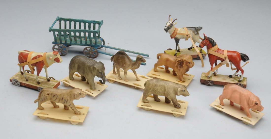 Lot of Antique Toys.: Made in Germany miniature papier-maché horse on wheels (ankles need gluing), cow and goat; papier-maché and wood wagon with tin wheels; 6 celluloid animals on celluloid bases with wheels. Sweet litt