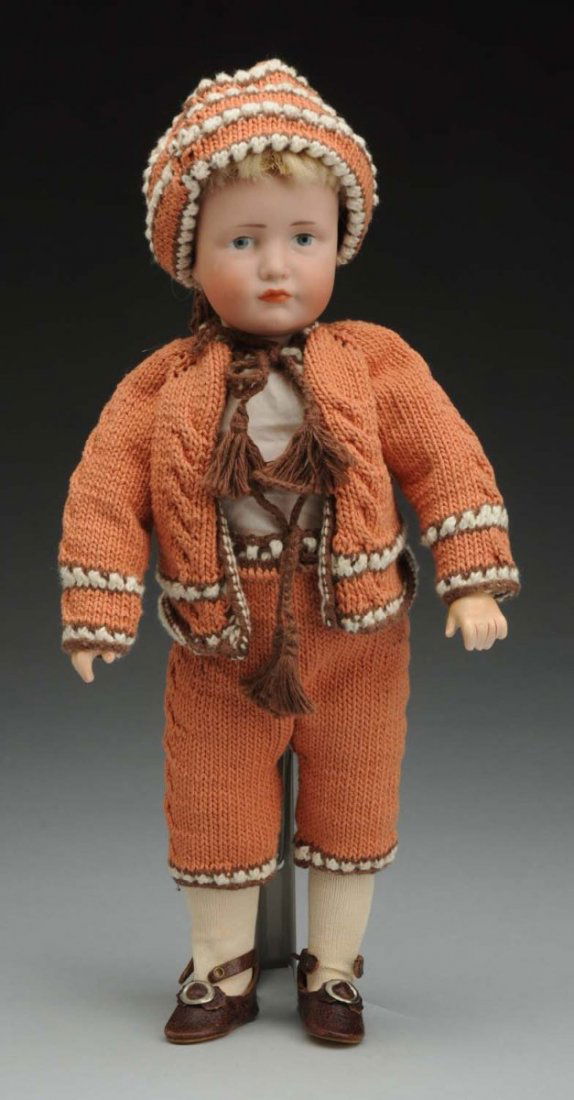 Pouty K & R Character Doll.: German bisque socket head incised “K [star] R 114 30” by Kammer & Reinhardt (wig pulls), tapered eyebrows, painted blue eyes, black eyelash line, closed pouty mouth with nice modeling detail, moha