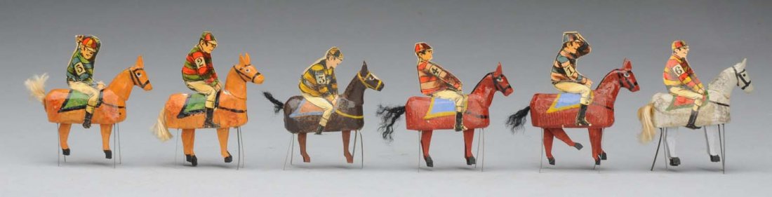 Lot of 6: Horses with Riders.: Set of antique wood horses with tin stands so that legs can dangle, each with a mounted paper jockey ready to race. Interesting little group! Condition (Excellent). Size Each: 2 - 1/2" T.