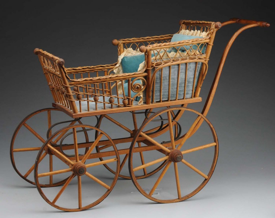 Victorian Wicker Doll Carriage.: 4-wheeled carriage with lovely wicker work bed, velvet and lace lining, wood wheels. Exceptionally nice to display several prized dolls! Condition (Excellent). Size 29" L.