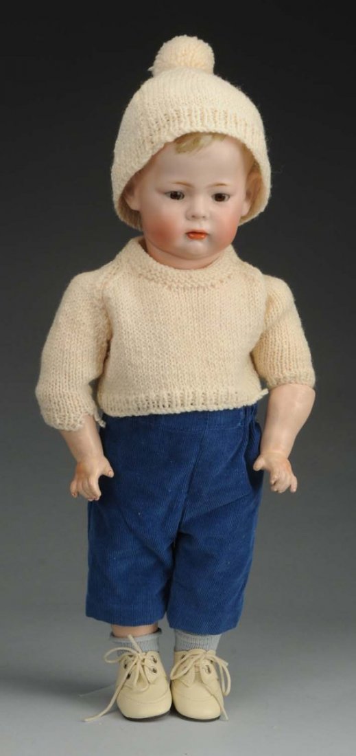 Delightful Pouty K & R Character Doll.: German bisque socket head incised “K [star] R S & H 115 42” made by Kammer & Reinhardt, desirable model called “Philip” with molded blonde curly hair, multi stroked eyebrows, brown stationary 