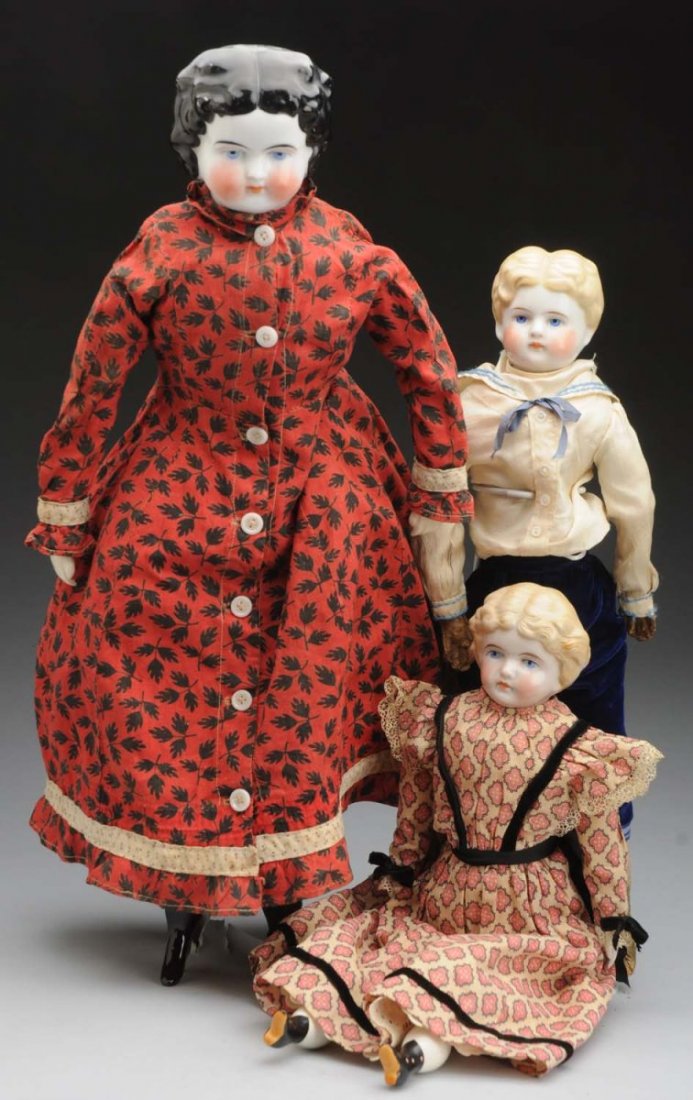 Lot of 3: German China Dolls.: Shoulder head incised with Dotter patent date Dec 7/80, black painted hair with curls (some wear), replaced but not brand new cloth body with ceramic limbs with black boots, appropriate antique cotton