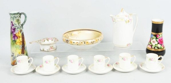 Lot of Nippon Glass.: Includes one marriage pitcher, a chocolate set with six cups and six saucers, a tea strainer, and a nut bowl. Minor chips. Condition (Excellent). Size 11" T.