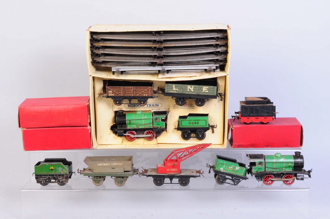 Assortment of Hornby O Gauge Trains.: Includes 0-4-0 scratched and worn paint. Wind-up. Good condition. Tender to match with matching condition missing a wheel set. Hornby rotary tipper has scratches some rust. Good condition. Hornby Ten 