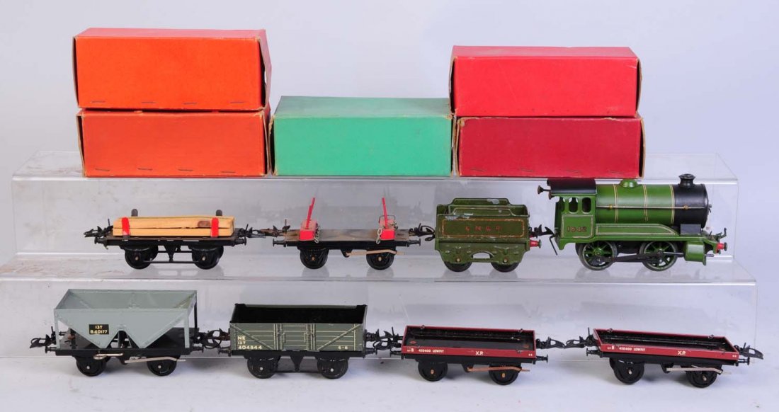 Hornby Locomotive & 5 Freight Cars.: Includes Hornby 0-4-0 locomotive and tender. Wind-up. locomotive complete and all original. Tender has some scratches and paint chips. Hopper car complete in original box. Flat car missing a load has 