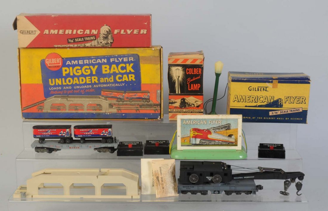 American Flyer Set.: No.23830 Piggy back unloader and car. In original box. Car and trailers are present. Unloader is present. Box is dirty. No.944 crane car complete and all original. No.566 whistling billboard in origin