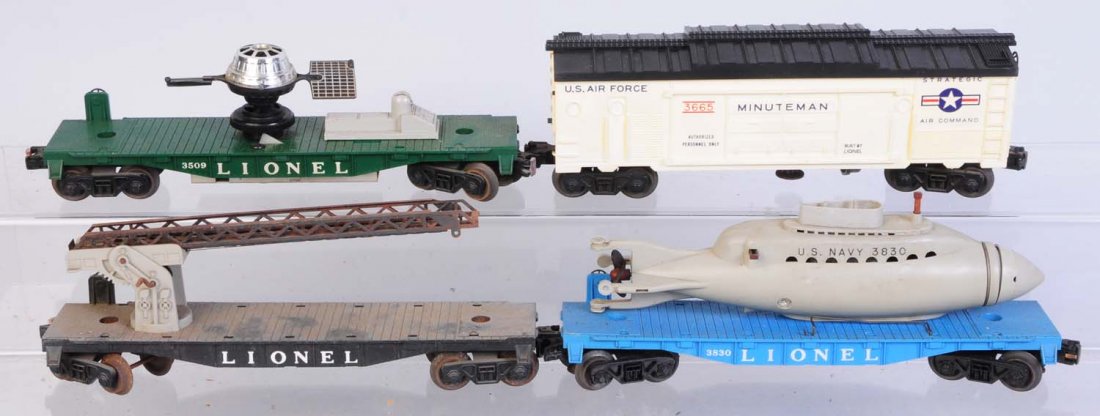 Lot of 4: Freight Cars.: Mostly military. Includes No.3665 Minute man box car. Side shows some yellowing. Black roof has original rocket. No.3509 Satellite car missing satellite dish. Has original satellite. Lionel ladder car