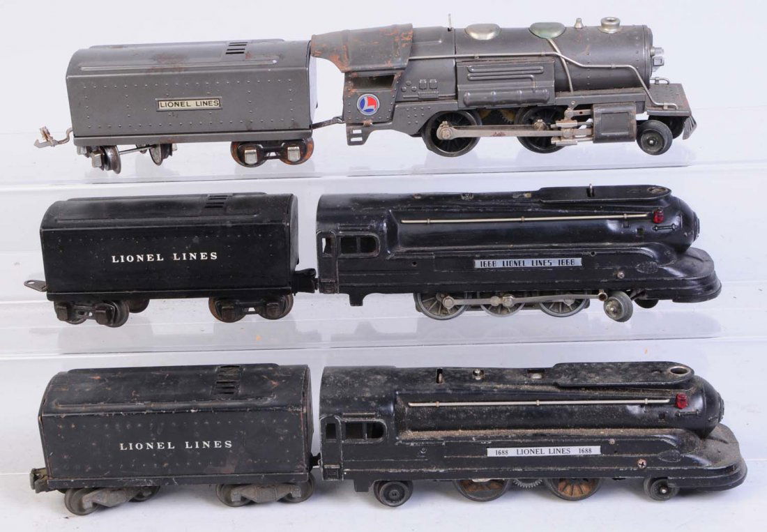 Lot of 3: Lionel Steam Locomotive & Tenders.: Pre-war. No.1668, No. 1688 and No. 259. Black No.1668 steam locomotive missing rear truck, missing slide shoes some scratches and paint chips. Good condition. No.1654W whistle tender complete has scra